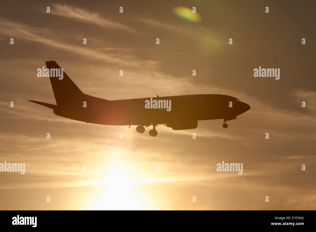 Silhouette of commercial jet flying Stock Photo