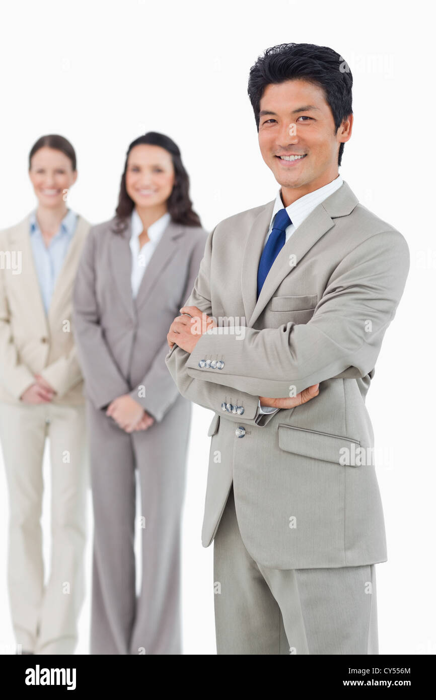 Confident smiling businessman with his employees behind him Stock Photo ...