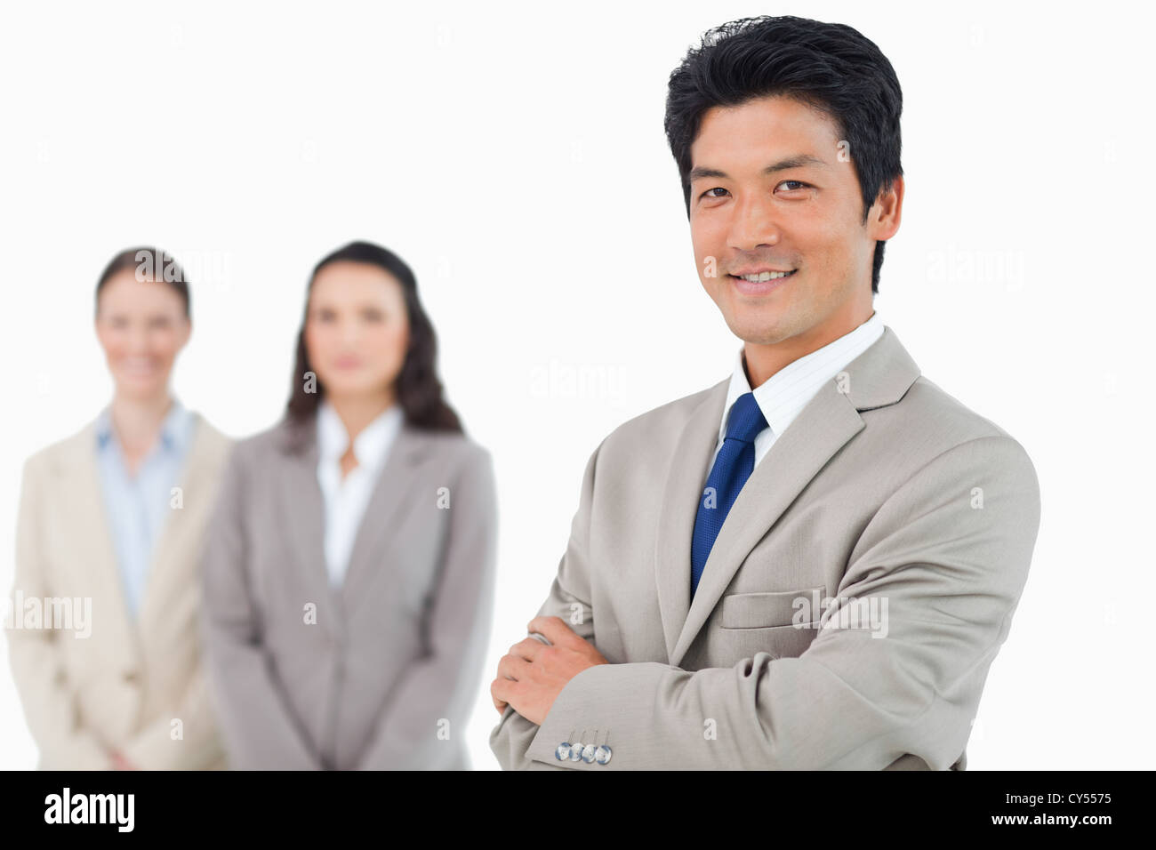 Confident smiling businessman with his team behind him Stock Photo - Alamy