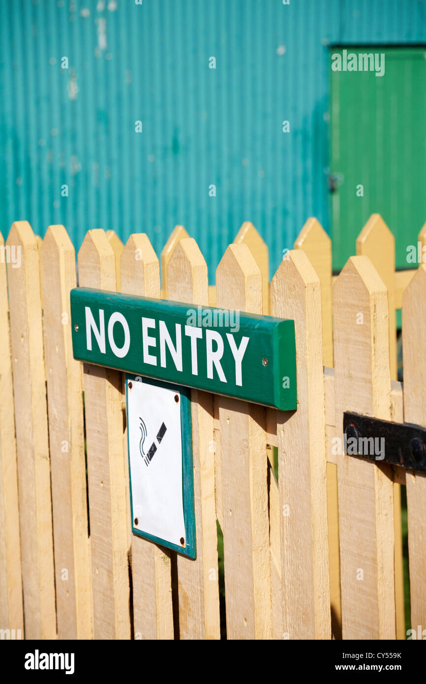 No Entry sign and faded no smoking sign on gate Stock Photo