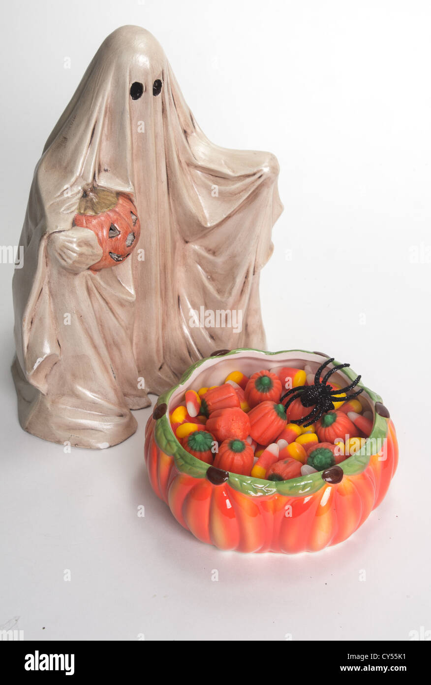Halloween ghost with Jack O'Lantern and candy corn filled candy dish isolated on white