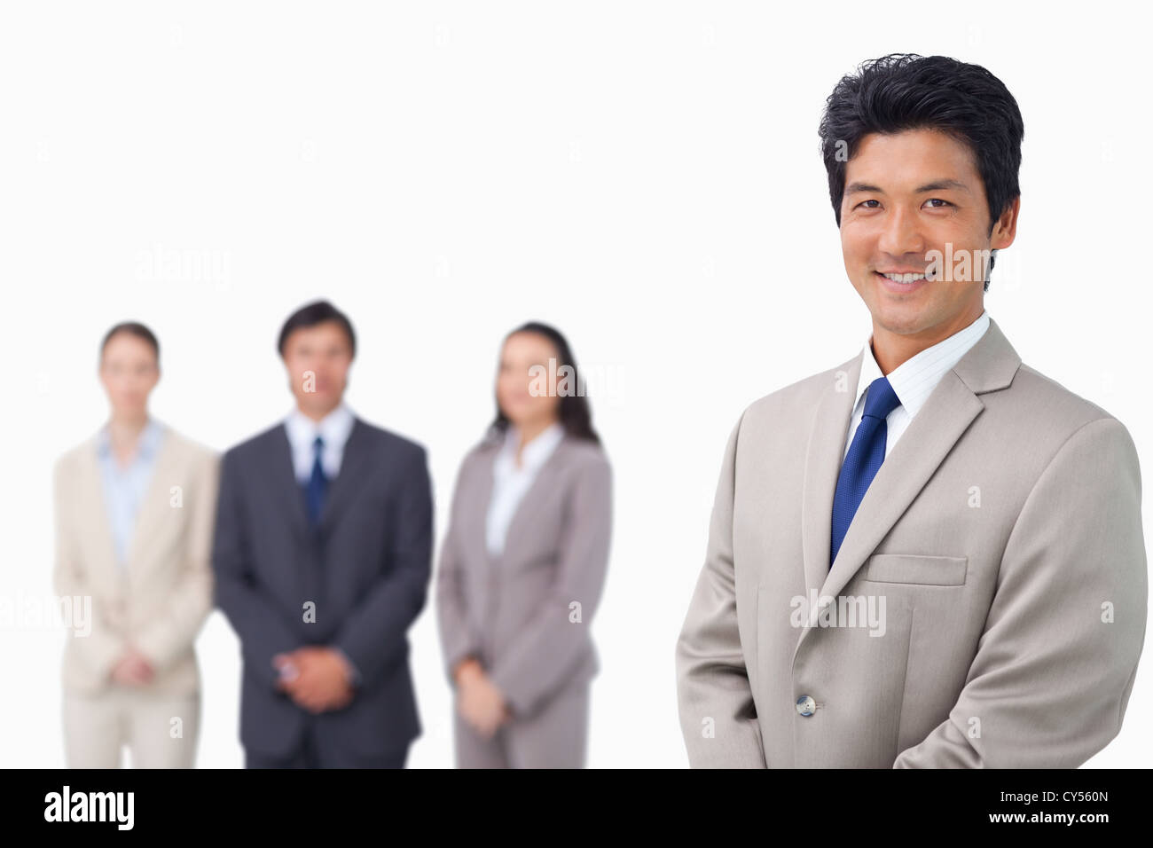 Businessman standing with his team behind him Stock Photo - Alamy