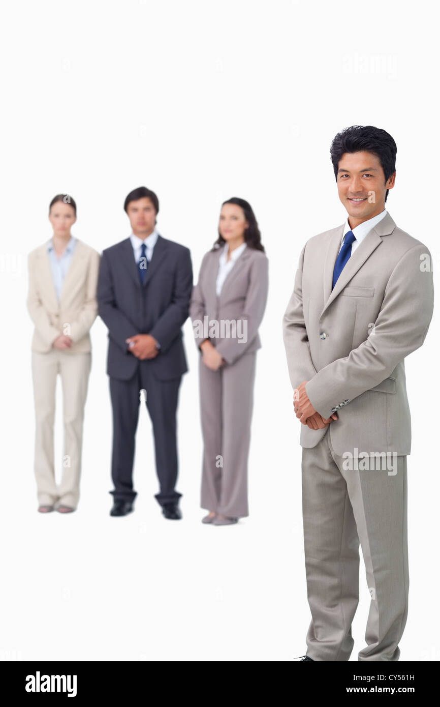 Businessman standing with his associates behind him Stock Photo - Alamy