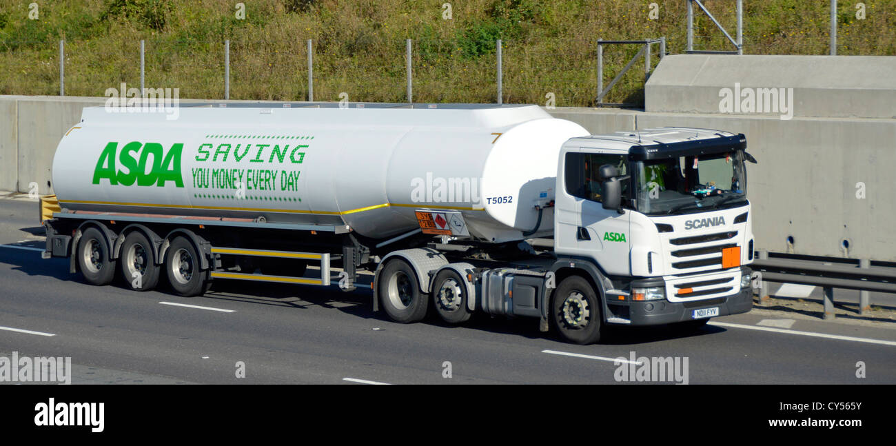 Asda supermarket fuel delivery tanker behind Scania truck on motorway