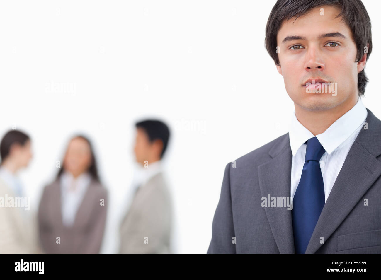 Young businessman with team behind him Stock Photo - Alamy
