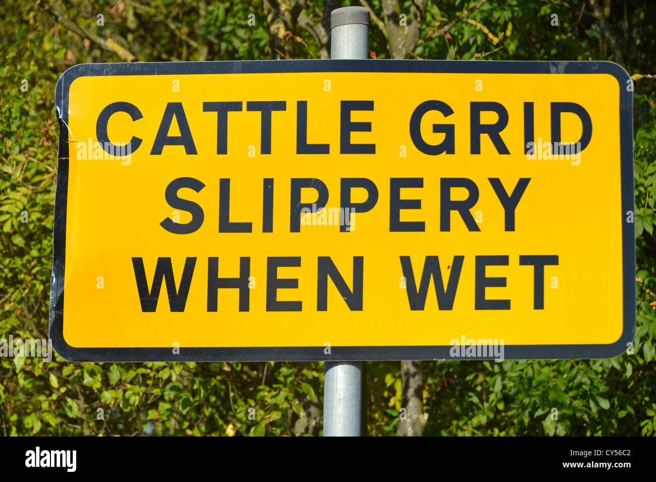 Slippery When Wet Hazard Warning Sign On Approach To Cattle Grid Stock Photo Alamy