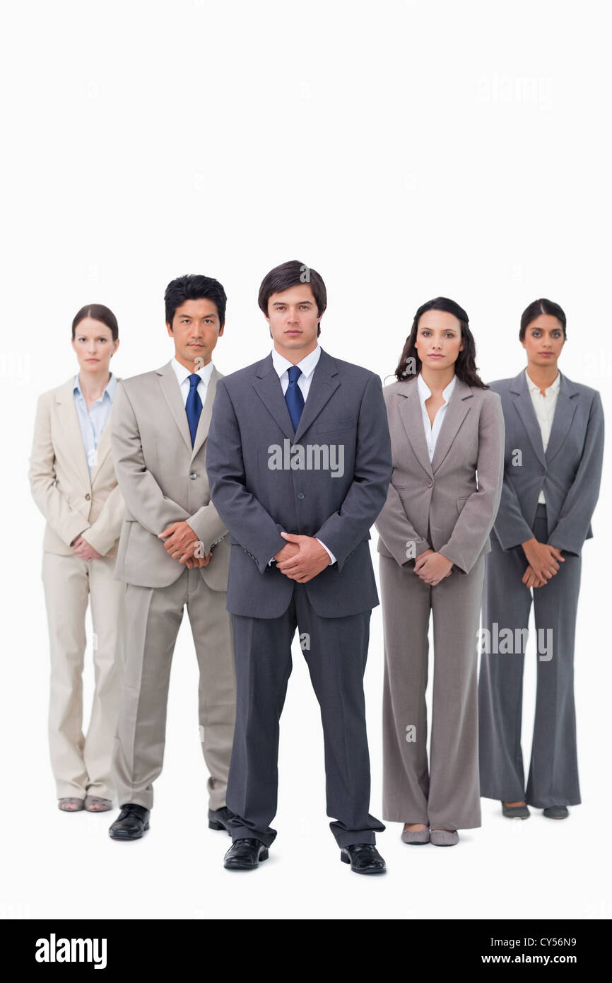 Businessman standing with his team Stock Photo - Alamy