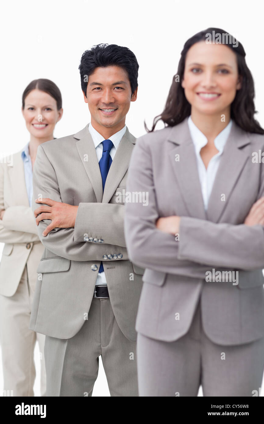Smiling Business team standing with folded arms Stock Photo - Alamy