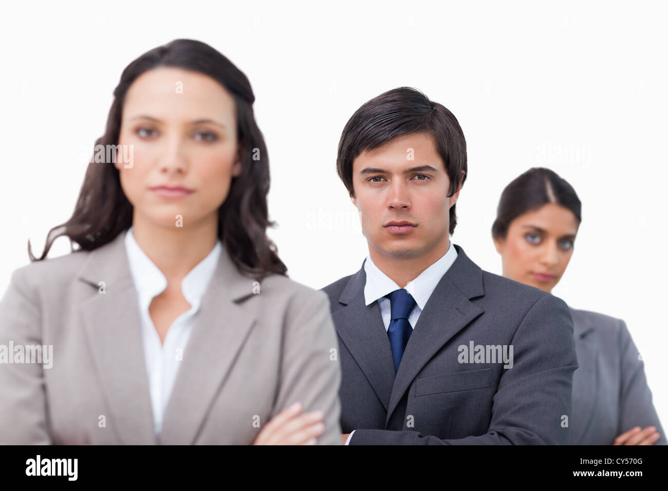 Serious business team with arms folded Stock Photo - Alamy