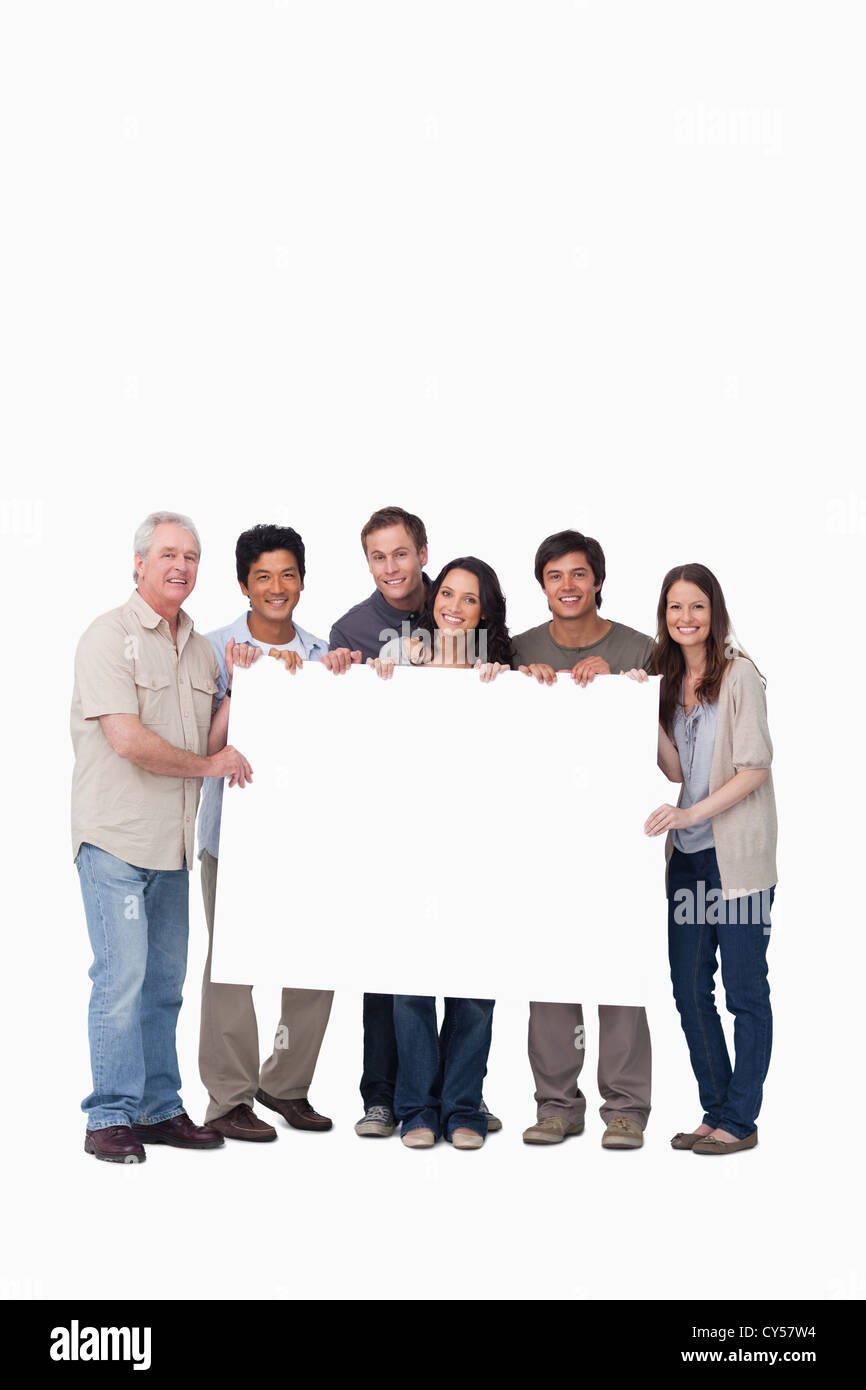 Smiling group of friends holding blank sign together Stock Photo - Alamy