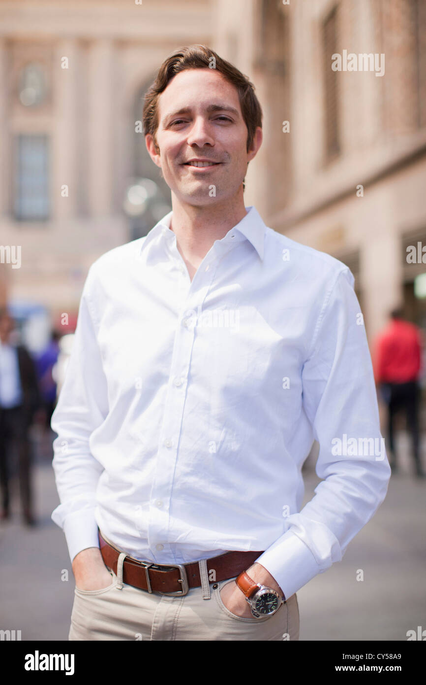 USA, New York State, New York, Portrait of man wearing white shirt and holding hands in his pockets Stock Photo