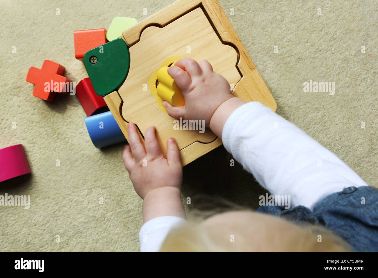 child plating with shape sorter Stock Photo