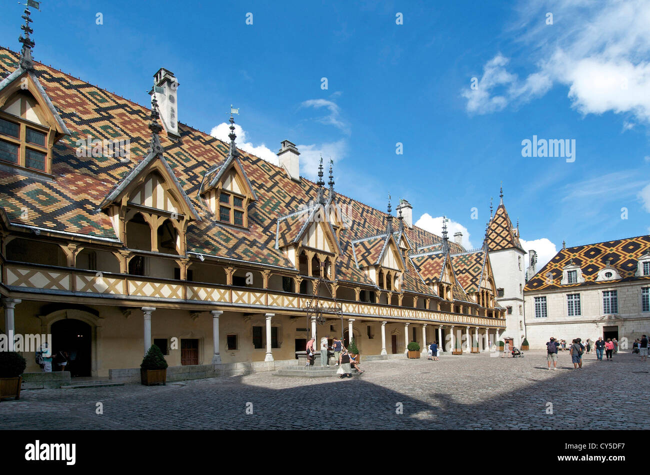 A lavish hotel room in a luxury hotel in Beaune, Burgundy, France, with a  Queen bed, sitting area, and chandelier Stock Photo - Alamy