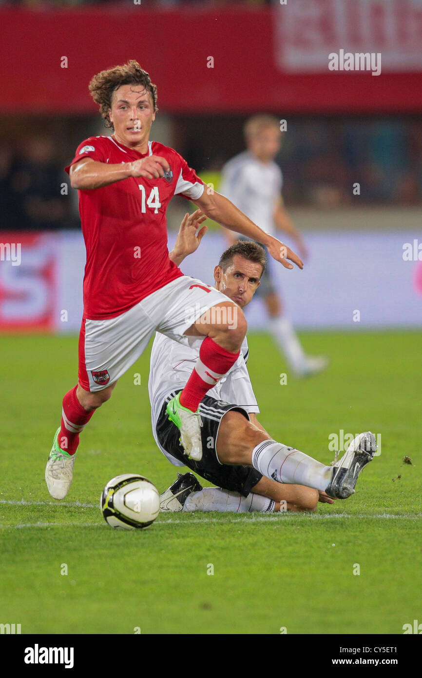 VIENNA, AUSTRIA - SEPTEMBER 11 Julian Baumgartlinger (#14 Austria) and Miroslav Klose (#11 Germany) fight for the ball. Stock Photo