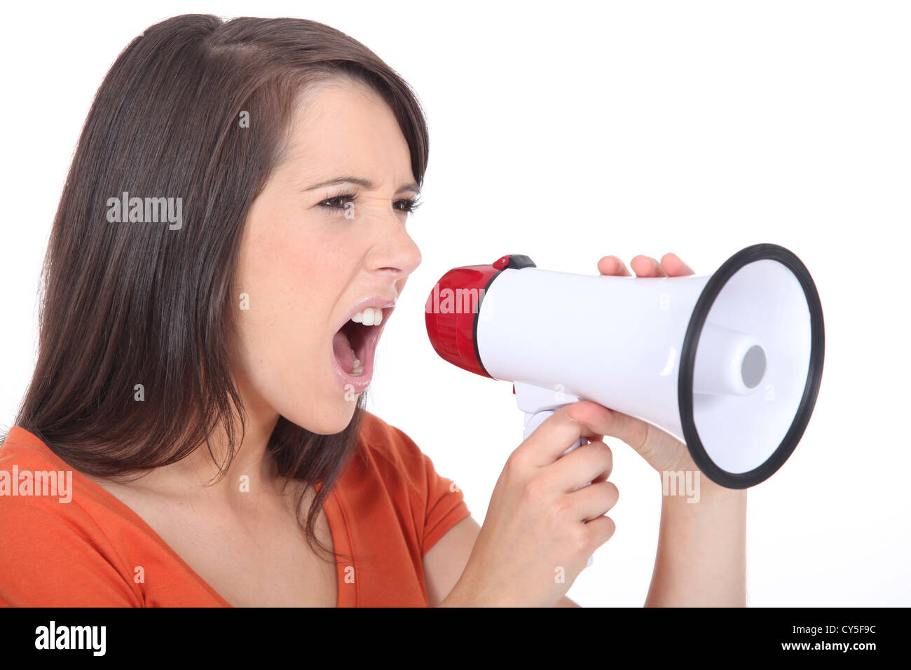 Angry woman screaming in speakerphone Stock Photo