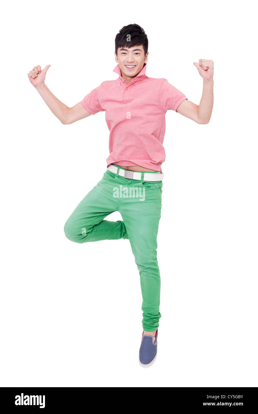 Happy young man jumping with thumbs up Stock Photo