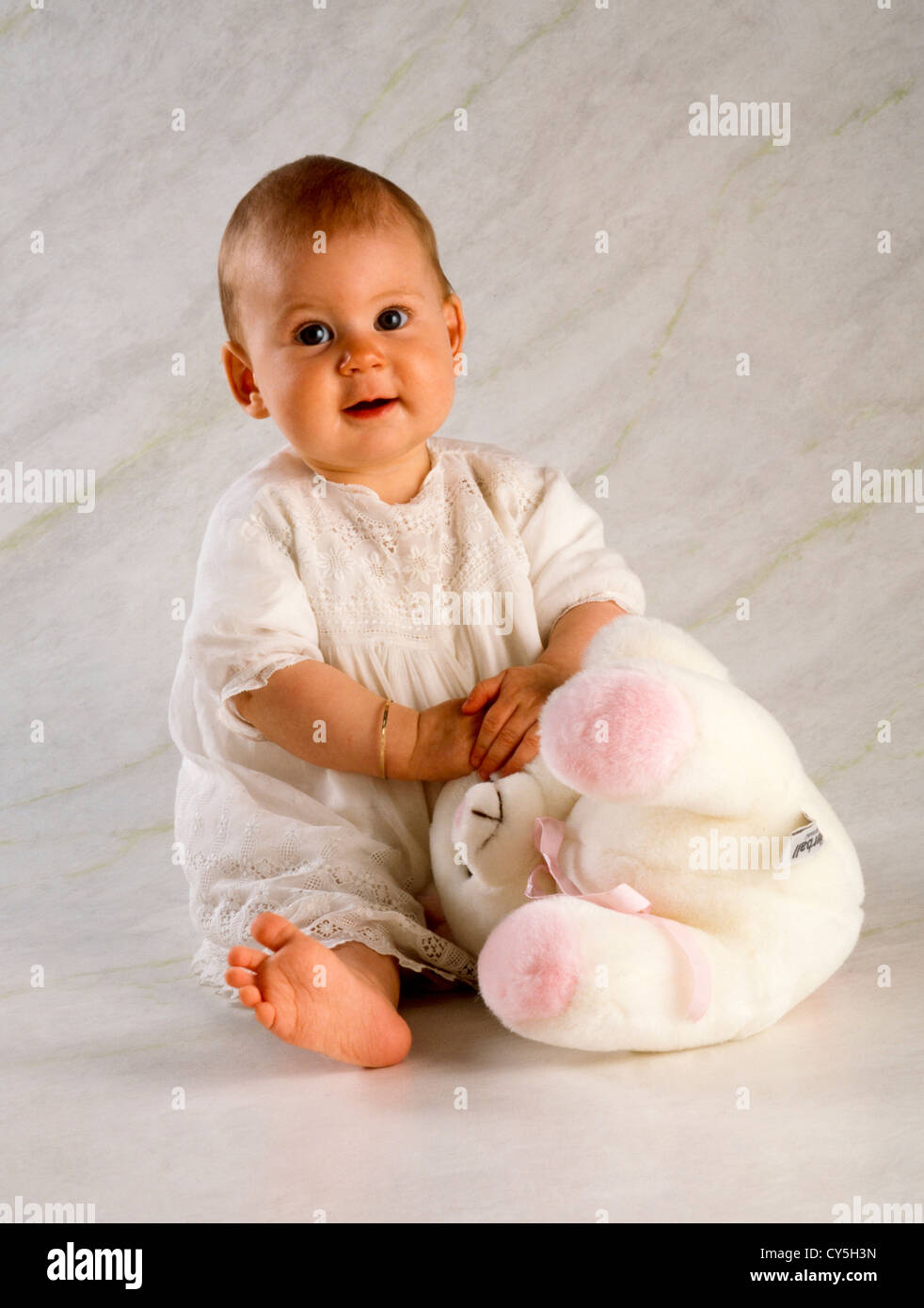 SIX MONTH BABY GIRL WITH SOFT TOY Stock Photo