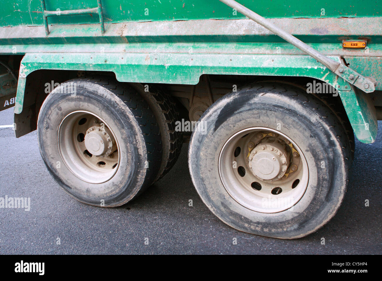 the-rear-wheels-of-an-hgv-truck-as-it-travels-along-a-road-in-england-CY5HP4.jpg