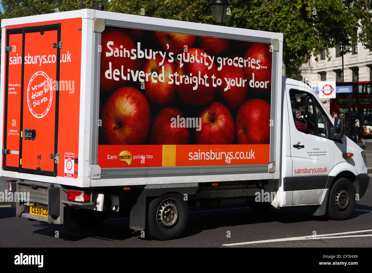 A Sainsburys home delivery truck traveling along a road in London
