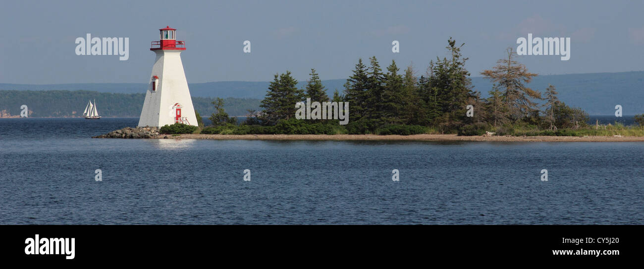 Canada Nova Scotia Cape Breton Baddeck Bras d'Or Lake lighthouse with schooner Atlantic Maritimes Stock Photo