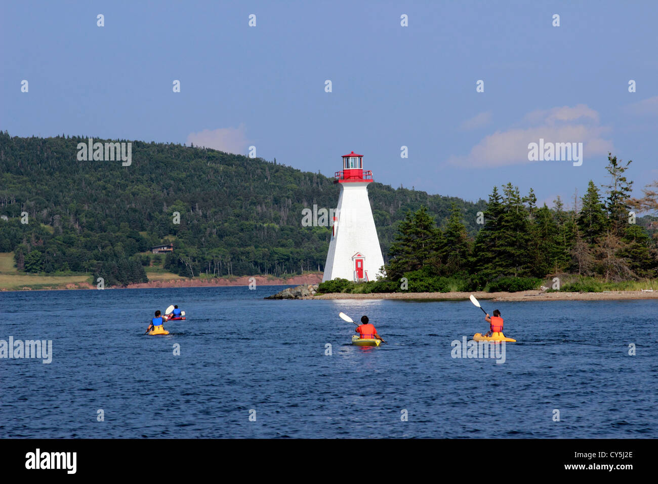 Canada Nova Scotia Cape Breton Baddeck Bras d'Or Lake lighthouse with kayaks Stock Photo