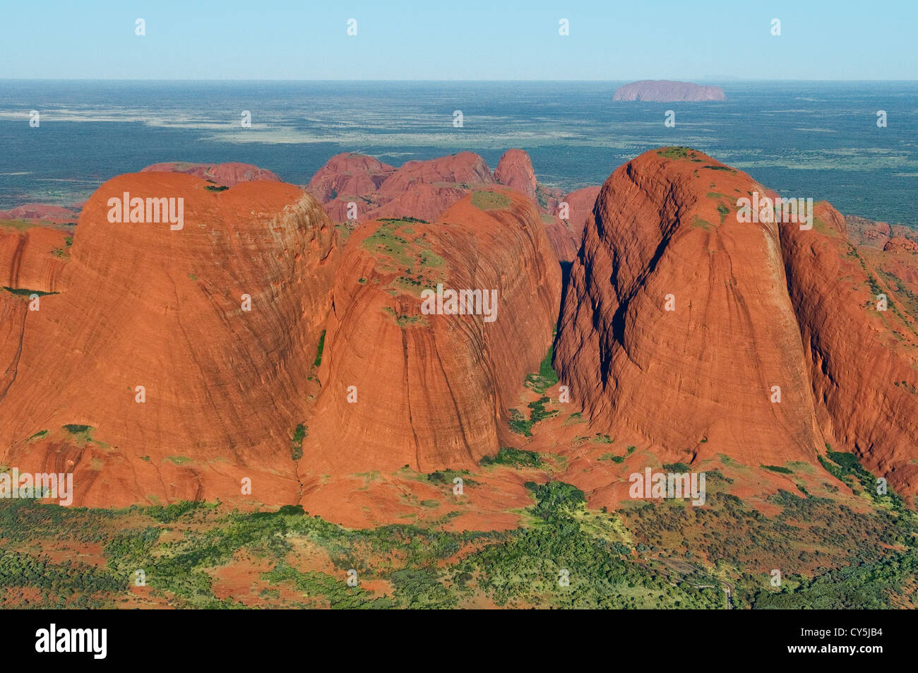 Aerial of the western domes of Kata Tjuta with Uluru in the distance. Stock Photo