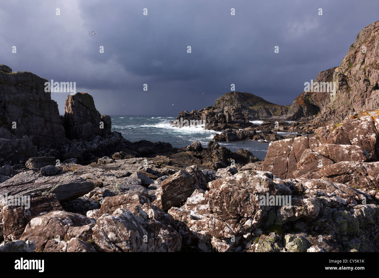 Stormy skies over rocky beach and headland at the Point of Sleat, Isle of Skye, Scotland, UK Stock Photo