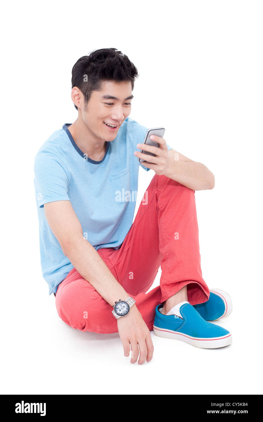 Happy young man and a mobile phone Stock Photo - Alamy