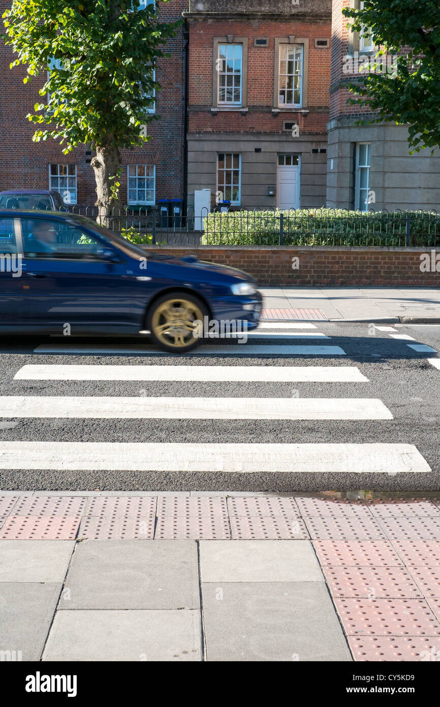 Car driving over pedestrian crossing UK Stock Photo