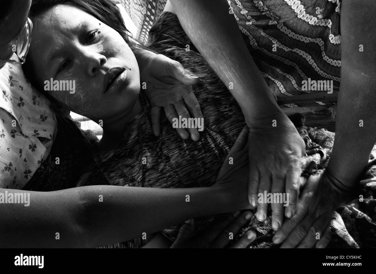 Cyclone Nargis survivor being comforted by her family in Irrawaddy area in the Republic of the Union of Myanmar Stock Photo