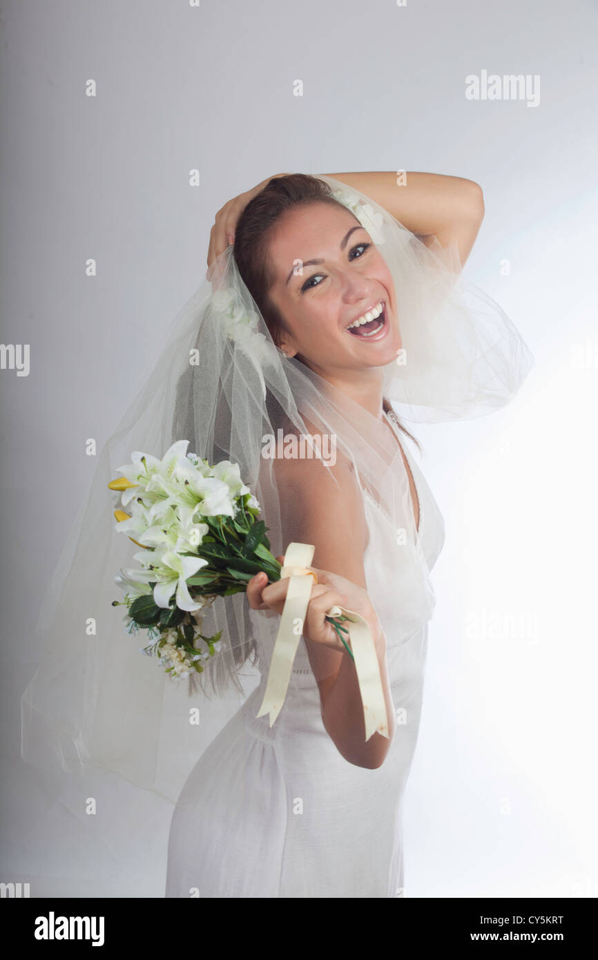 young bride in veil with bouquet Stock Photo - Alamy