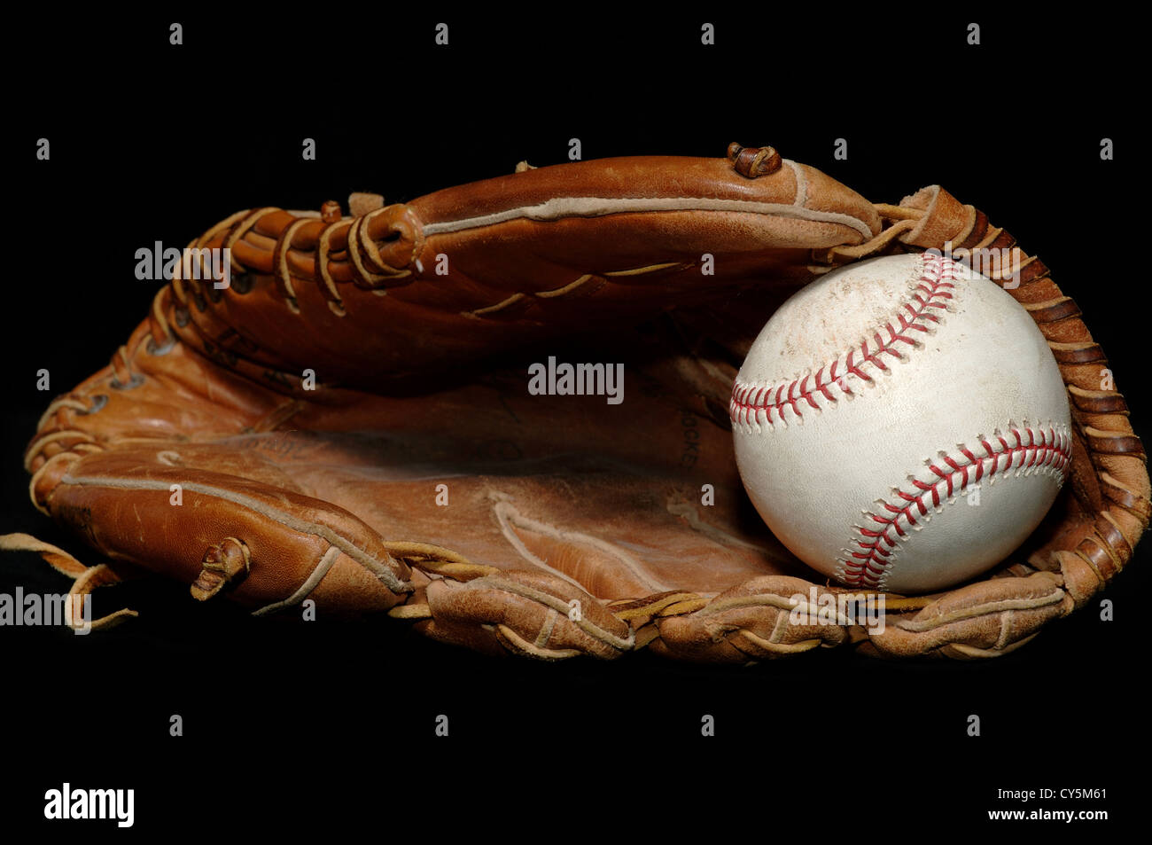 Baseball in Glove on Black Stock Photo