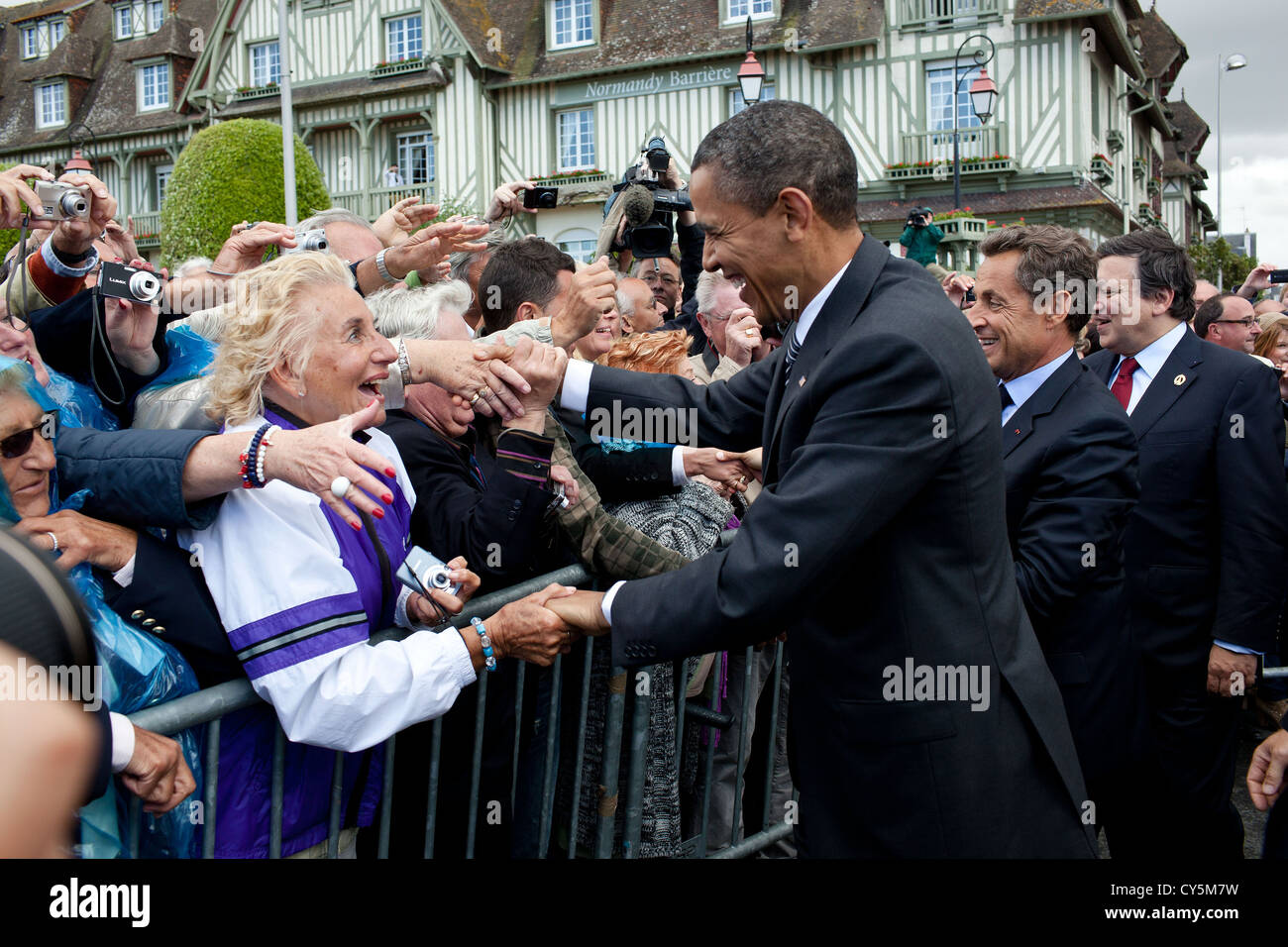 US President Barack Obama, French President Nicolas Sarkozy and European Commission President JosŽ Manuel Barroso greet people on the street before attending the G8 Summit May 26, 2011 in Deauville, France. Stock Photo