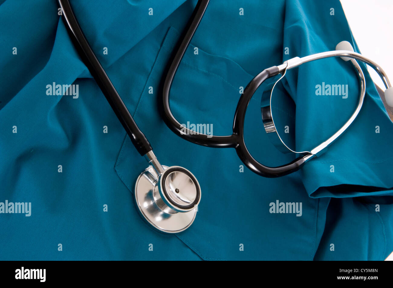 Medical Supplies - Stethoscope on green scrubs on white background Stock Photo