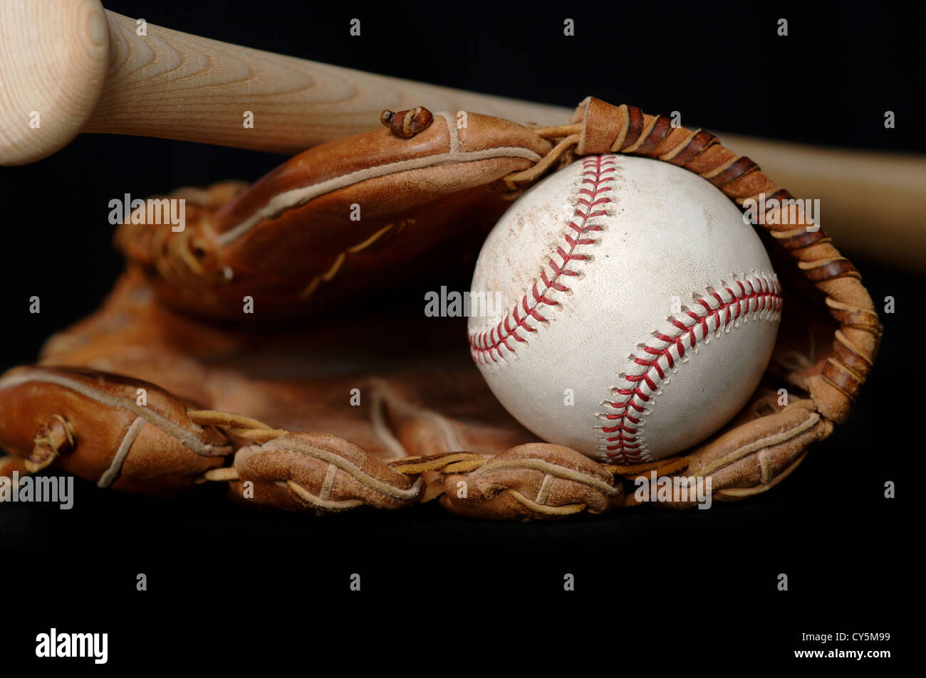 Baseball in glove and Bat on Black Stock Photo Alamy