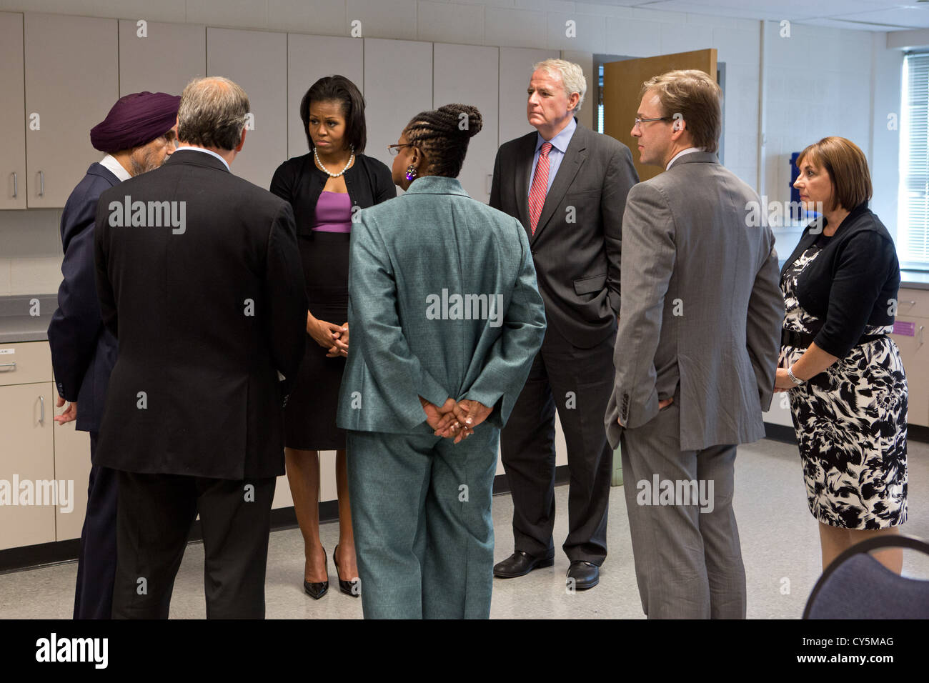 First Lady Michelle Obama talks with community leaders at Oak Creek High School August 23, 2012 in Oak Creek, Wisconsin. The First Lady visited Oak Creek in support of victims of the Sikh Temple shooting and the community of Oak Creek. The First Lady talks with from left Kulwant Singh Dhaliwal, Secretary of Board of Trustees for the Sikh Temple; Oak Creek Mayor Steve Scaffidi; Rep. Gwen Moore, D-Wis.; Milwaukee Mayor Tom Barrett; County Executive Chris Abele, Milwaukee County; and Tonette Walker, Governor Scott Walker's wife. Stock Photo