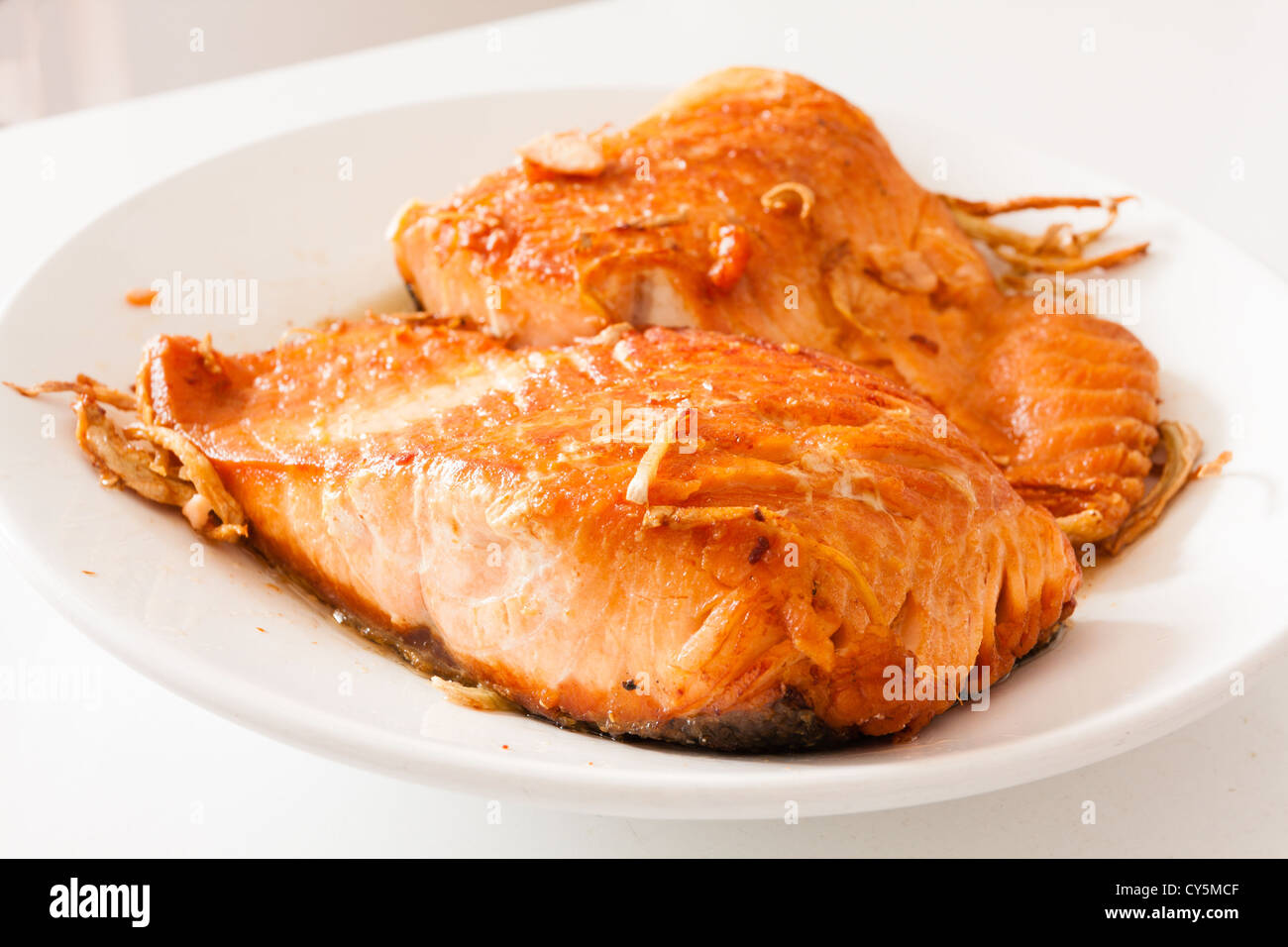 Pan-seared, sauteed Chilean salmon fillet with ginger on white plate background Stock Photo