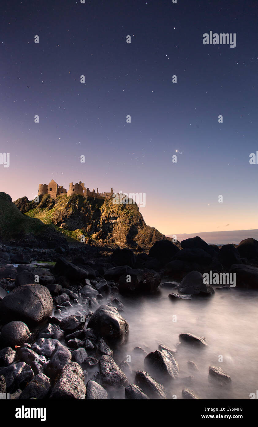 Dunluce Castle captured at night under moonlight. Stock Photo