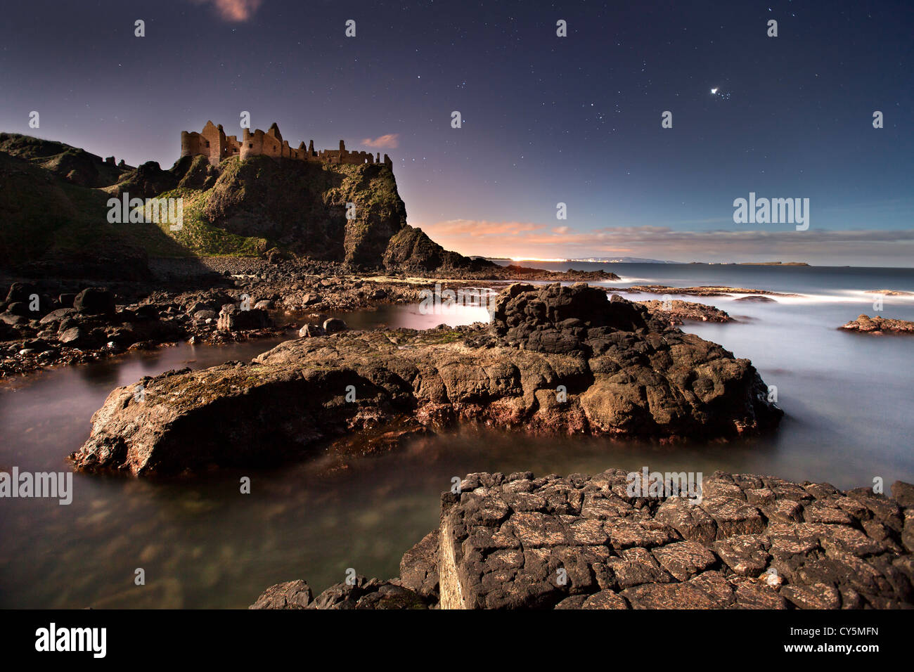 Dunluce Castle captured at night under moonlight. Stock Photo