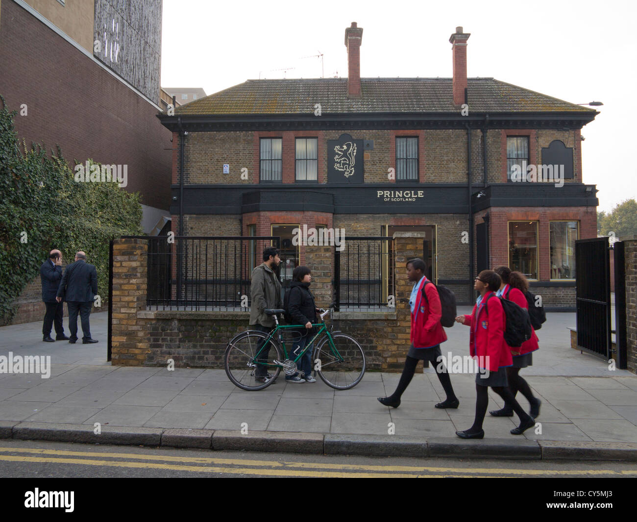 Local schoolchildren walk past luxury knitwear label Pringle of Scotland  new store in Hackney, London, next to Burberry outlet Stock Photo - Alamy