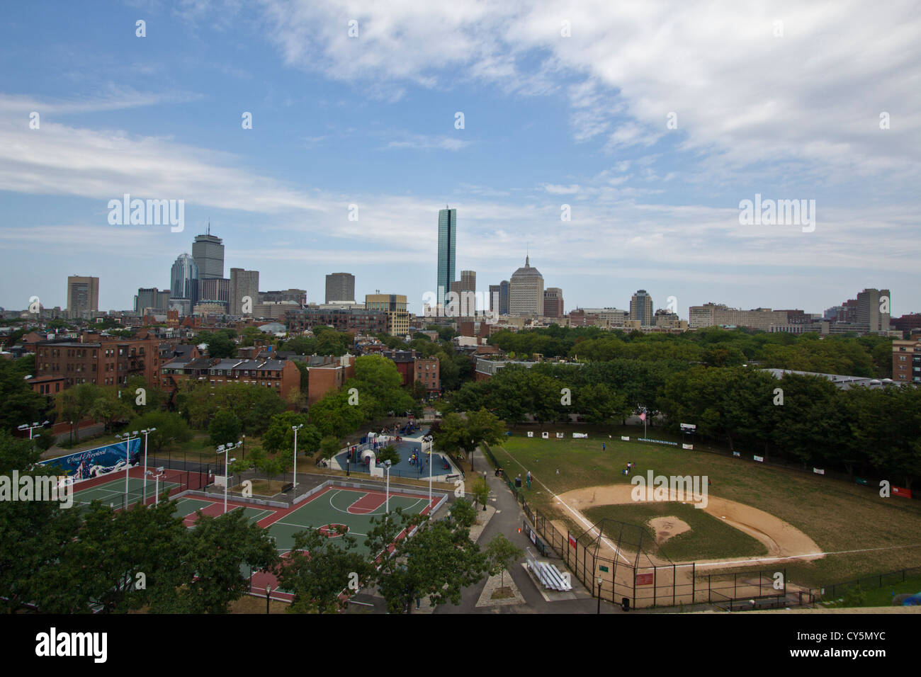 Boston skyline with outdoor basketball courts and baseball field in the