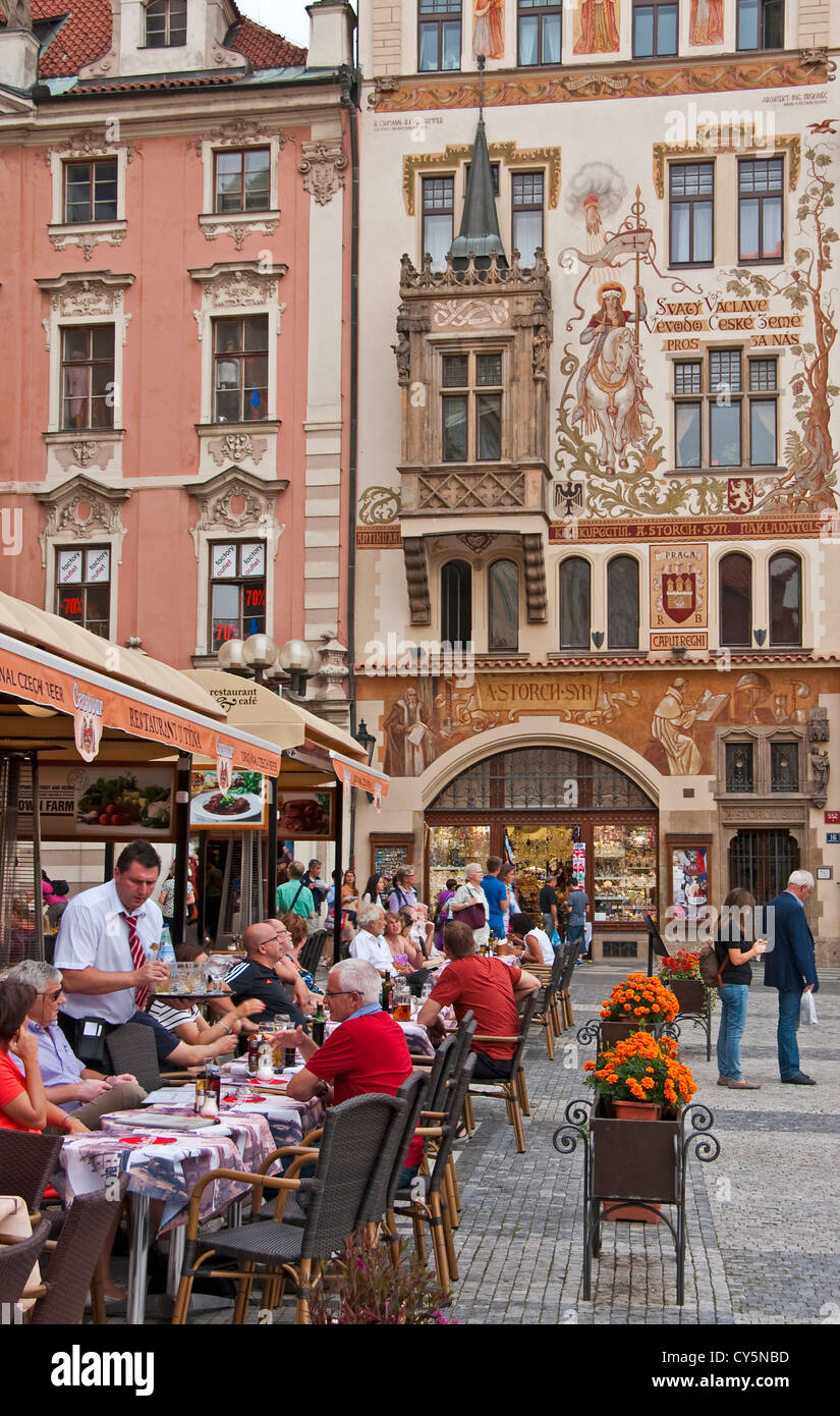 Restaurant patrons seated along Prague's Old Town Hall Square in summer. Stock Photo