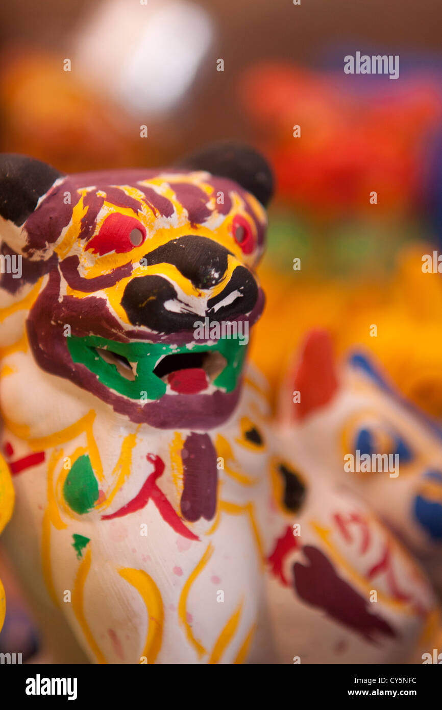 A popular activity for visitors to Ryukyu Village is to paint their own pottery Shiisa - the stone lion god of Okinawa, Japan. Stock Photo