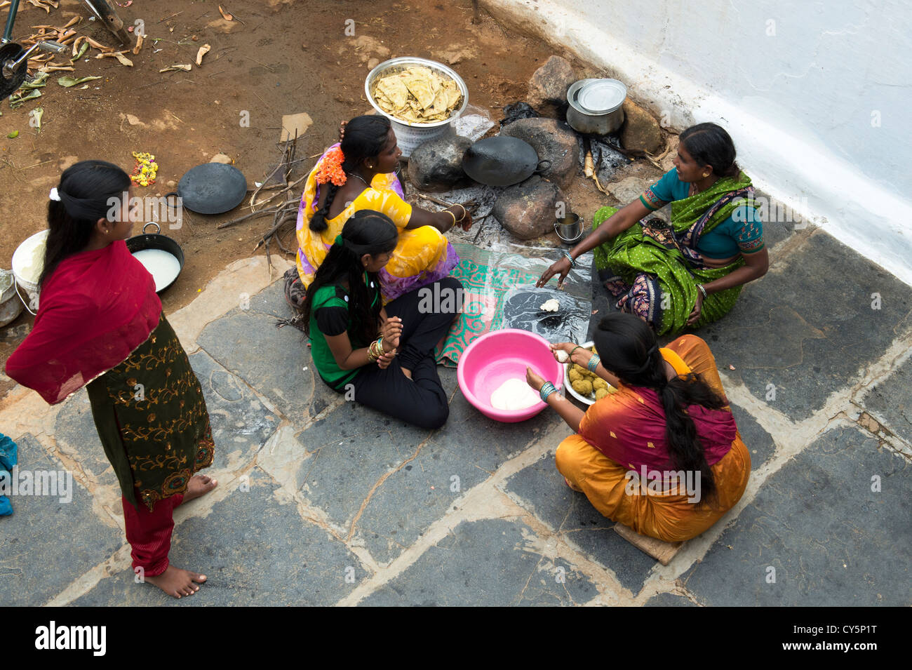 Indian women and girls making sweet jaggery filled chapathi for Dasara festival in a rural Indian village. Andhra Pradesh, India Stock Photo