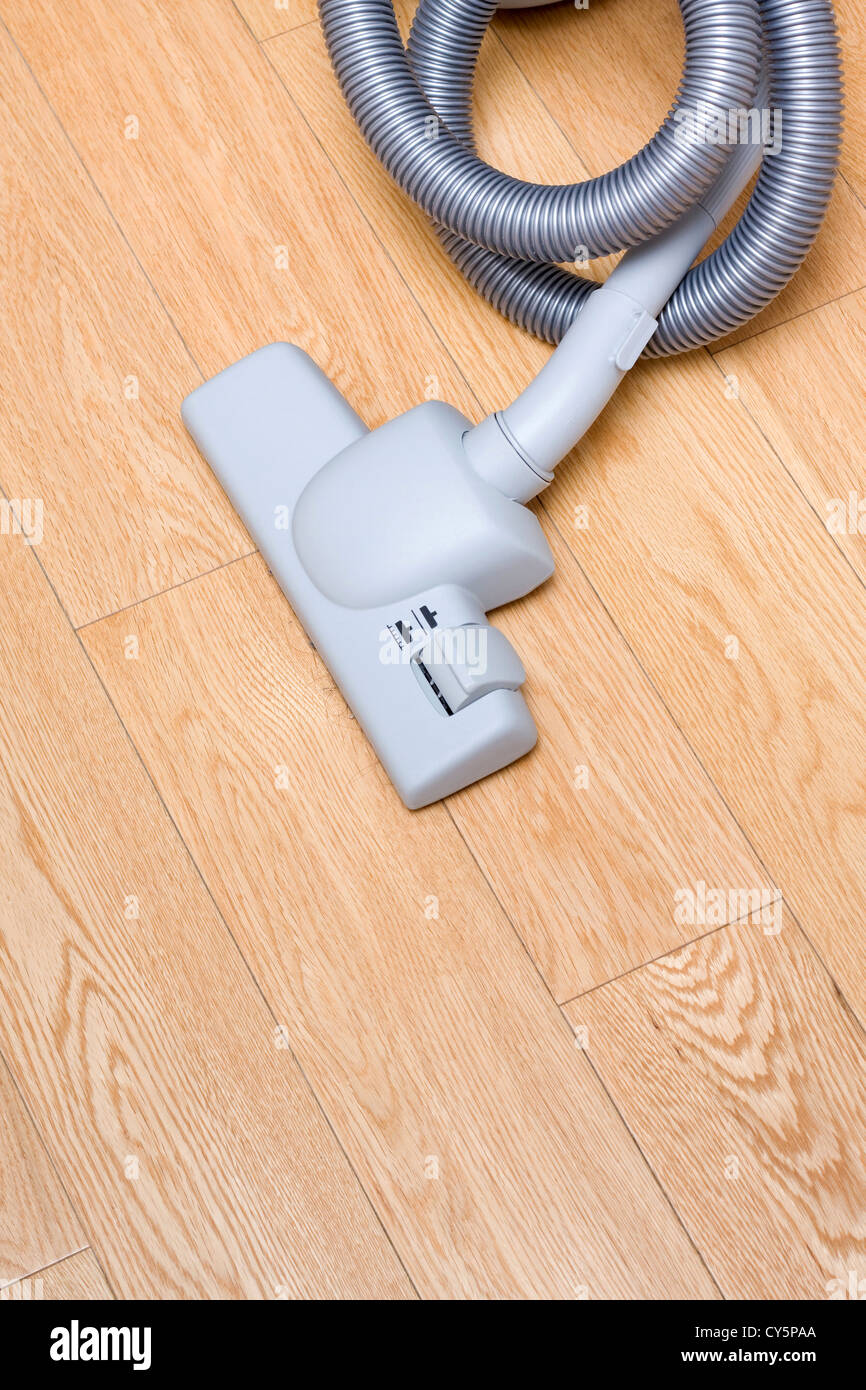 Vacuum cleaner on wood floor Stock Photo - Alamy