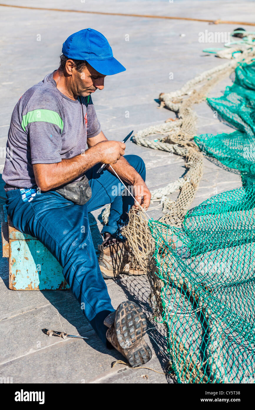 Fisherman Mending Fishing Net Stock Photo - Alamy
