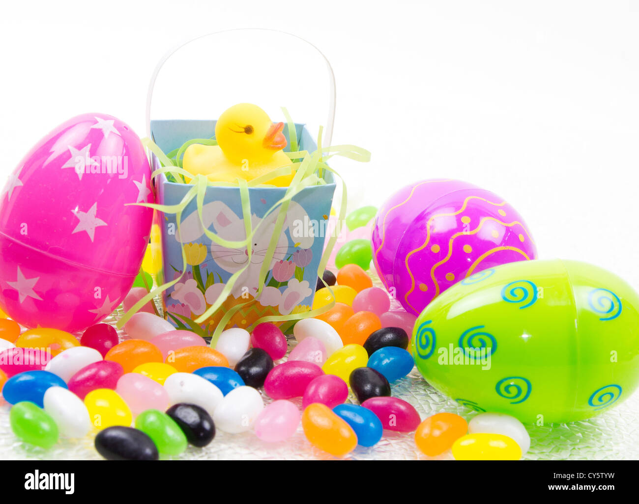 Yellow rubber duck in easter basket with easter eggs & jelly beans