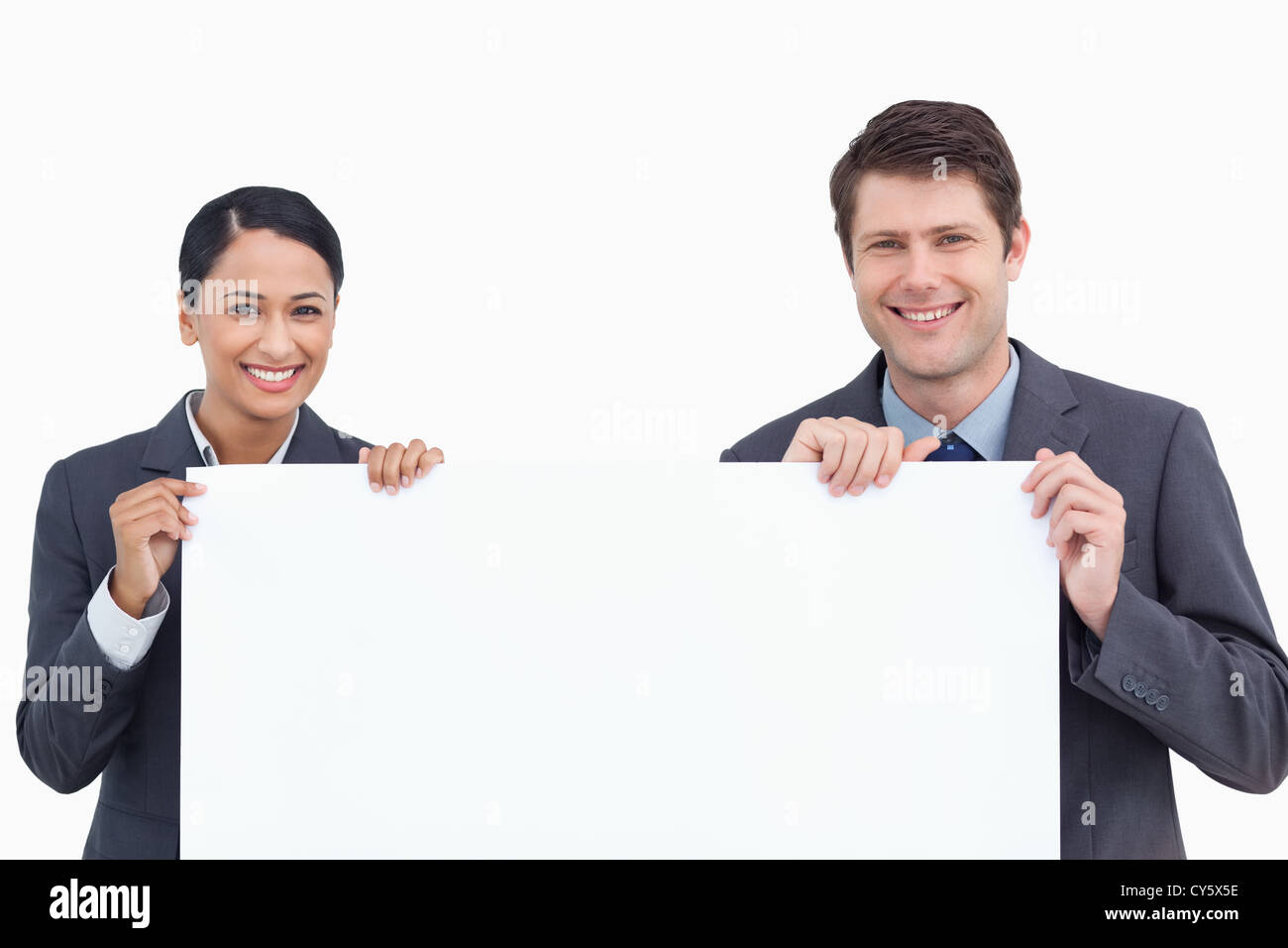 Close up of smiling salesteam holding blank sign Stock Photo