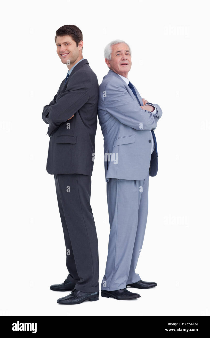Smiling businessmen standing back to back Stock Photo - Alamy