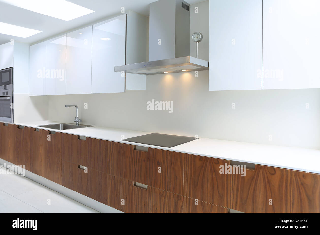 Actual modern kitchen in white and walnut wood interior house Stock Photo